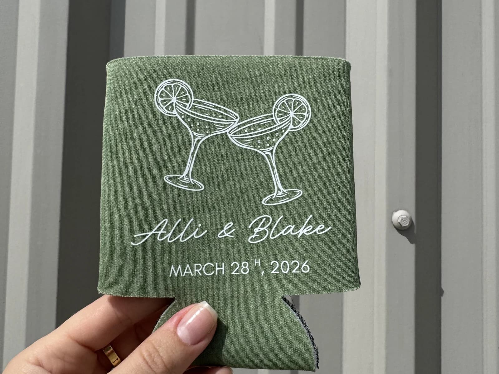 Green custom wedding koozie printed with names and cocktail glasses
