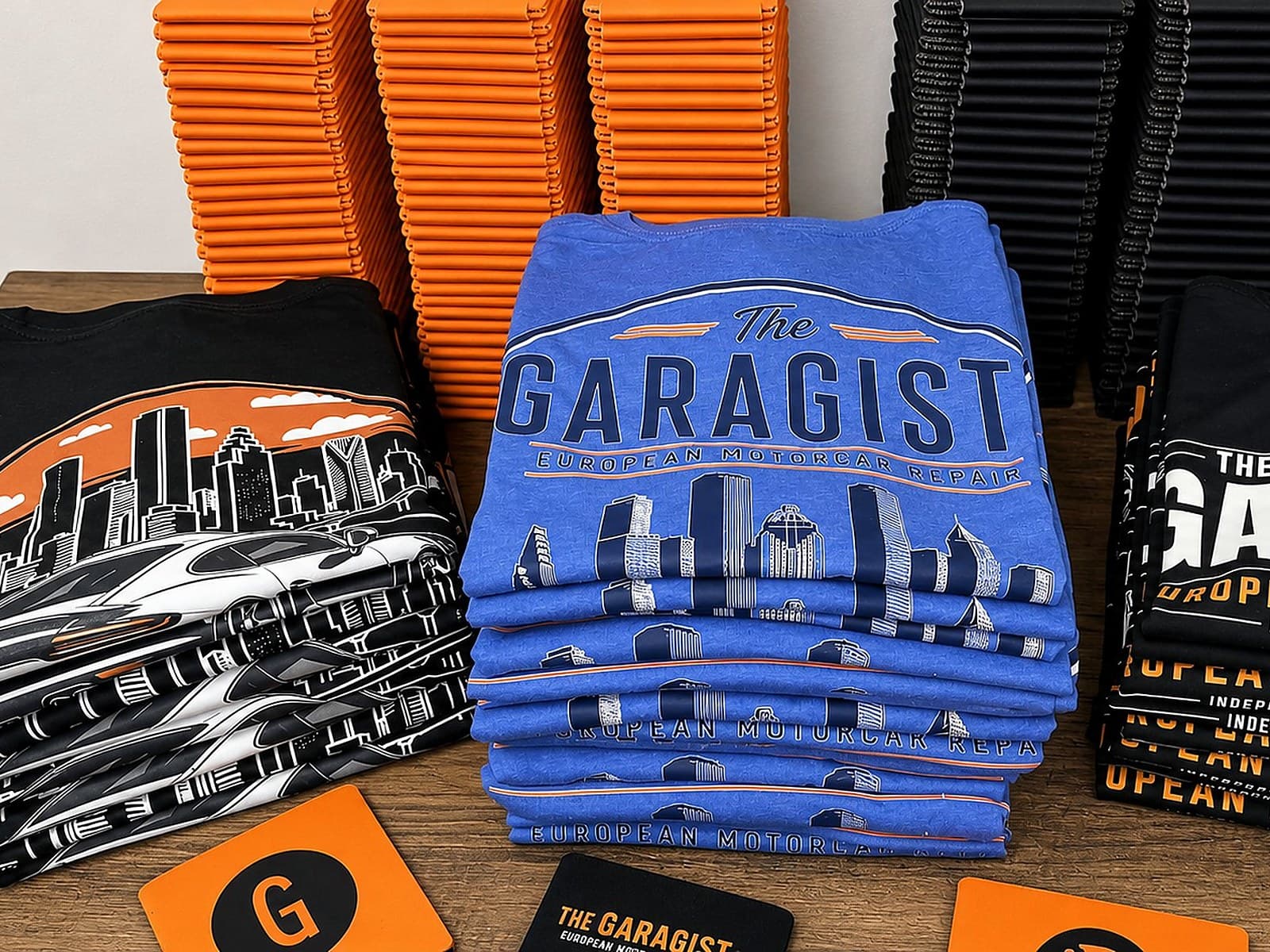 Cleaned Garagisti custom shirt stack with printed shop artwork